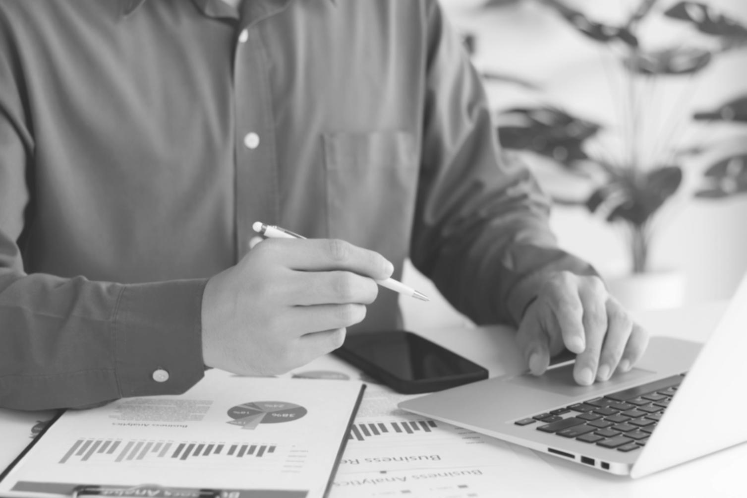 Professional workspace with financial documents and analysis tools